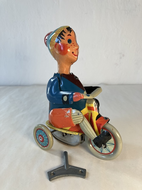 KLUK NA TŘÍKOLCE – PLECHOVÁ HRAČKA S PRUŽINOVÝM STROJKEM